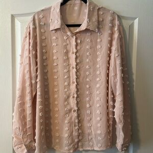 Woman’s pink button down blouse